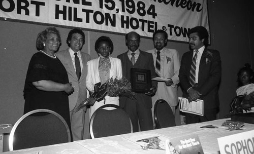 Father of the Year, Edward Villa posing with stepdaughter Tisha Boyd and others at a luncheon, Los Angeles, 1984