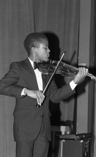 Young man playing the violin at the California Museum of Science and Industry, Los Angeles, 1986