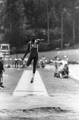 Carl Lewis completing a long jump, Los Angeles, 1982