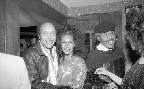 Mary Wilson posing with guests at her birthday party, Los Angeles, 1985