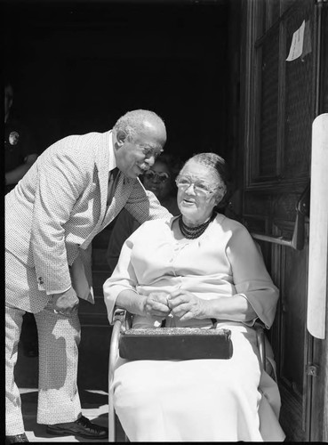 Gilbert Lindsay talking with an older woman in a doorway, Los Angeles, 1985