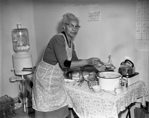 Woman serving food, Los Angeles, 1963