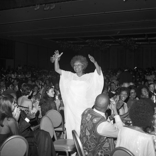 Maggie Hathaway standing among a seated crowd during the NAACP Image Awards, Los Angeles, 1978