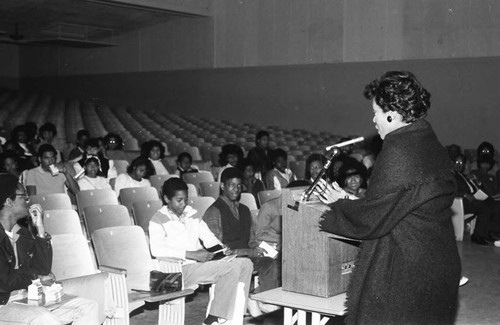 Career Day lecturer addressing students in an auditorium, Los Angeles, 1985