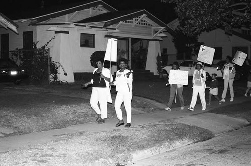 Neighborhood watch group marching against drugs and crime, Los Angeles, 1986