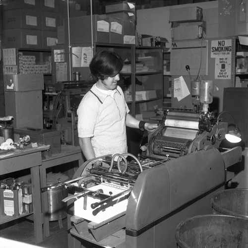 Man operating a duplicating machine at Compton College, Compton, 1972