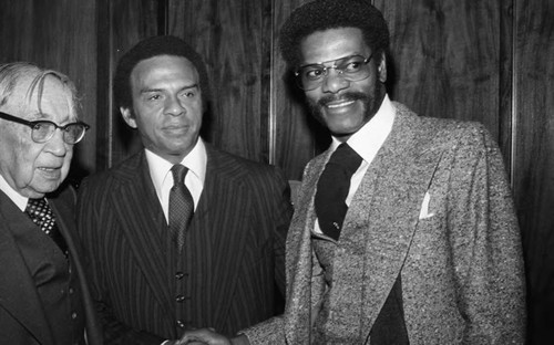 Dr. H. Claude Hudson shaking hands, Los Angeles, 1979