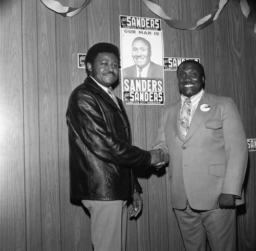 Hillard Hamm posing with Wesley Sanders Jr. on election night, Compton, 1975