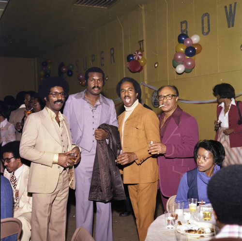 Donald Bohana posing with other guests at a Super Bowl party,Los Angeles, 1977