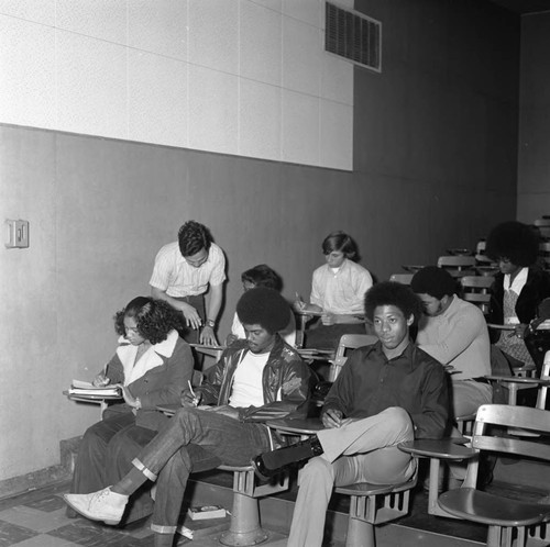 Instructor working with students at Compton College, Compton, 1973