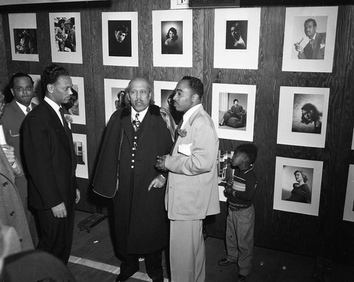 Bishop Charles M. Grace and Charles Williams talking with others at the California School of Photography Open House, Los Angeles, 1950