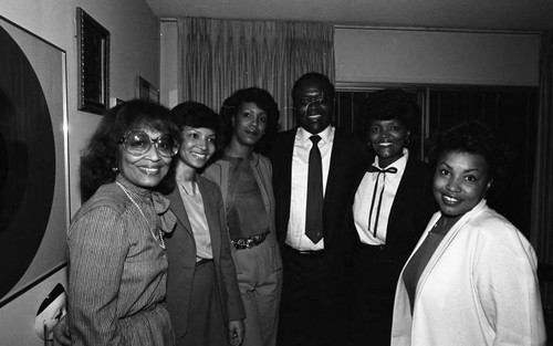 Guests at a Kelli Flowers cocktail party posing together, Los Angeles, 1983