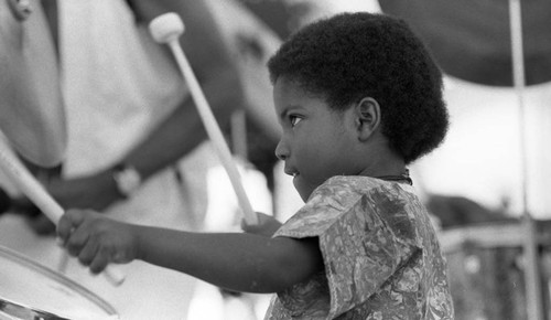 Young boy playing drums at the Watts Towers Festival of Drums, Los Angeles, 1982