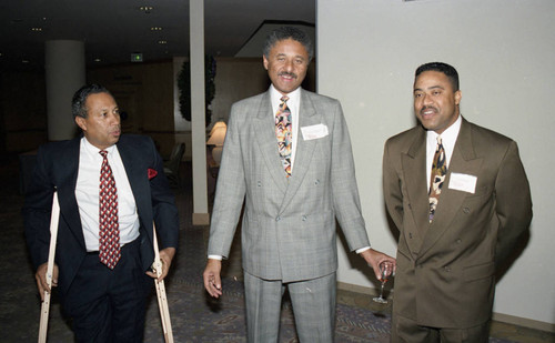 Atkins & Evans holiday party guests posing with Nelson L. Atkins, Los Angeles, 1994