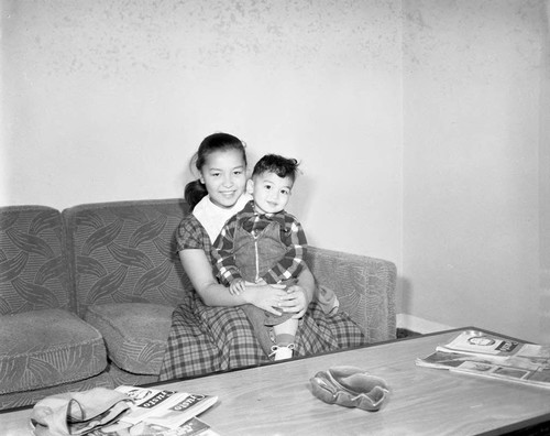 Woman holds toddler, Los Angeles