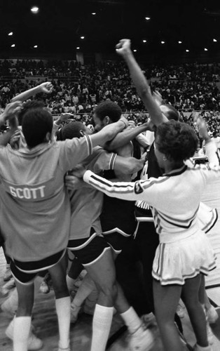 Banning basketball players and cheerleaders celebrating a city tournament victory, Los Angeles, 1983