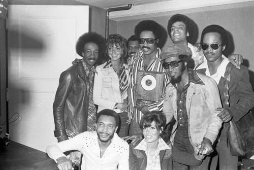 The Miracles posing with others during KGFJ's Soul Search event, Los Angeles, 1975