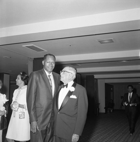 Dr. H. Claude Hudson at his testimonial dinner talking with Tom Bradley, Los Angeles, 1969