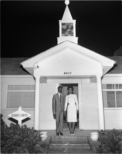 Bride and groom posing in front of a chapel, Los Angeles, 1965