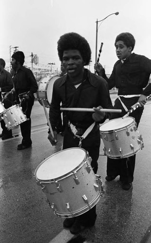 Drummers in a drill team marching in the Compton Christmas Parade Compton, 1973