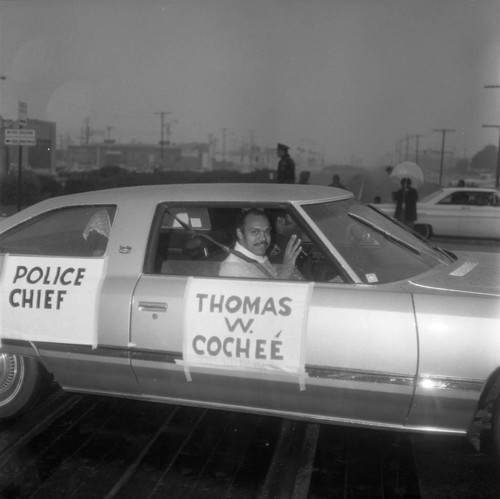 Thomas W. Cocheé waving from inside a car during the Compton Christmas Parade, Compton, 1973