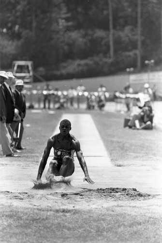 Carl Lewis completing a long jump, Los Angeles, 1982