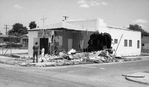 Man and woman surveying damage to Mt. Bethel Missionary Baptist Church, Los Angeles, 1987