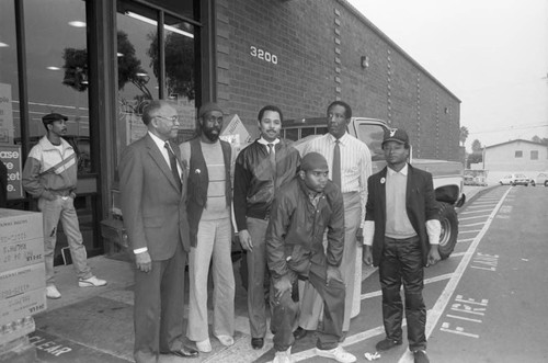 Ted Hayes and Larry Carroll posing with others during the "Goods for the Homeless" food drive, Los Angeles, 1986