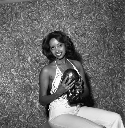 Debbie Creci posing with an NAACP Image Award, Los Angeles, 1978