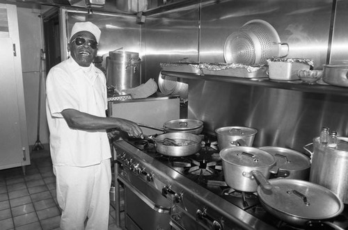 Ciro's Restaurant chef posing at the kitchen stove, Los Angeles, 1987