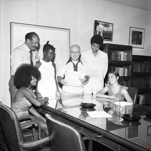 Gus Hawkins standing with others in an office, Los Angeles, 1972