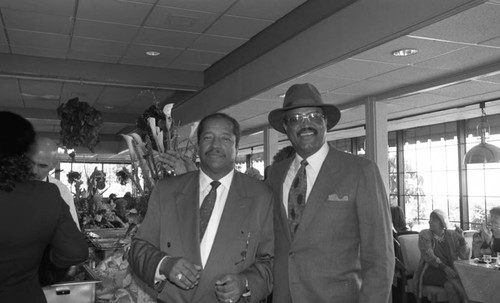 Frank Holoman posing with an unidentified man at the opening of his restaurant, Frank's Place, Los Angeles, 1998