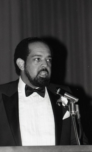 Alpha Kappa Alpha Sorority dance attendee speaking into a microphone, Los Angeles, 1984