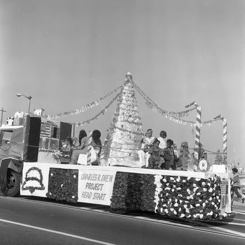 Watts Christmas Parade float for Project Head Start passing along the route, Los Angeles, 1975