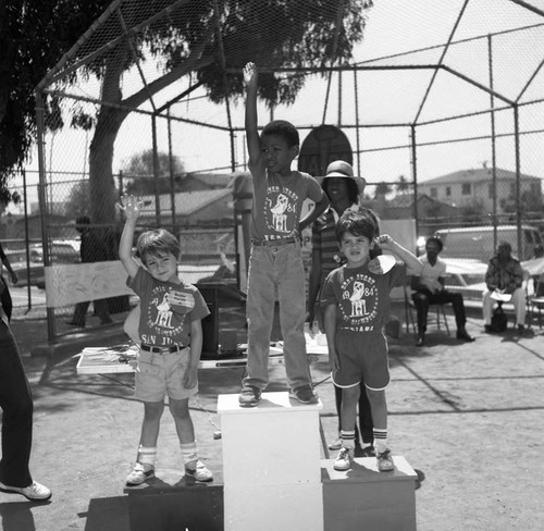 Children taking their place on a victory stand during a Mini-Olympics event, Venice, California, 1984