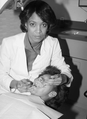 Dr. Gwen Kelly examining a patient, Los Angeles, 1983