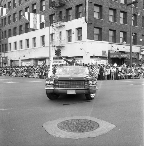 Charles William riding in parade, Los Angeles, 1963