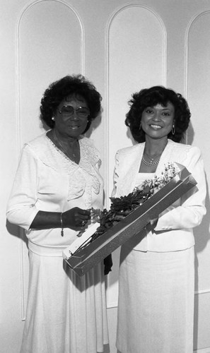 Geraldine Toliver receiving roses from Dr. Ernesdyne Dave-Burnett, Los Angeles, 1987