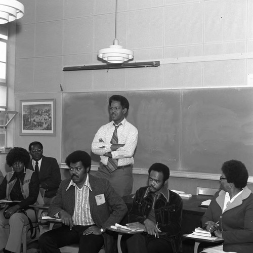 Man speaking during a meeting at Compton College, Compton, 1973