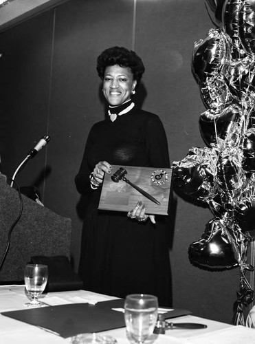 Lois Anderson holding an award from the Crenshaw Chamber of Commerce, Los Angeles, 1989