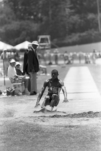 Carl Lewis completing a long jump, Los Angeles, 1982