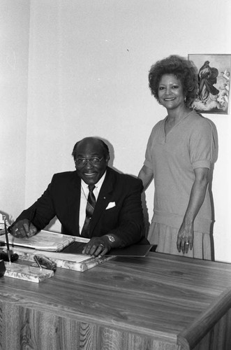 Bishop E. Lynn Brown posing at a desk in an office, Los Angeles, 1986