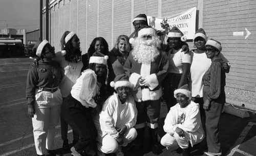 Participants posing together at a Head Start Holiday Toy Lift event, Los Angeles, 1993