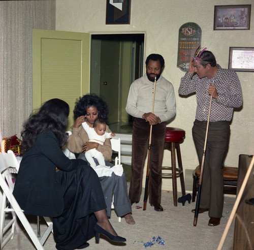 Diana Ross holding her infant daughter at a party, Los Angeles, 1972