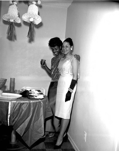 La Doris McClaney posing with a woman at a wedding shower, Los Angeles, 1960