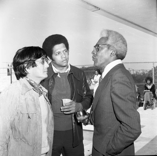 Bayard Rustin talking with two unidentified men, Los Angeles, 1973