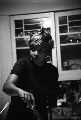 Patricia Crowder cutting a cake, Los Angeles, ca. 1980