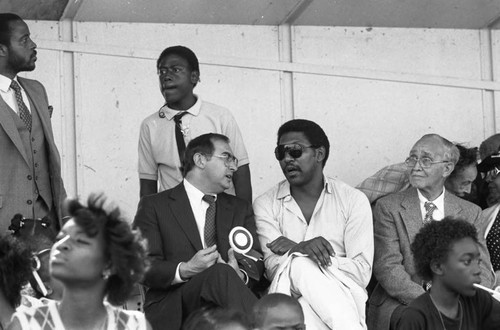 Willis Edwards talking with Robert Philibosian during the 16th annual Easter parade, South Central Los Angeles, 1984