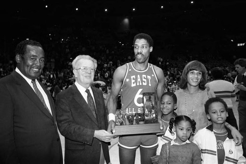 Julius Erving and his family posing with his NBA All-Star Classic MVP award, Inglewood, 1983