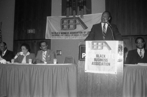 Black Business Association event speaker Roger E. Mosley addressing an audience, Los Angeles, 1983